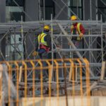 Men in Helmets Working on Scaffolding on Building Site